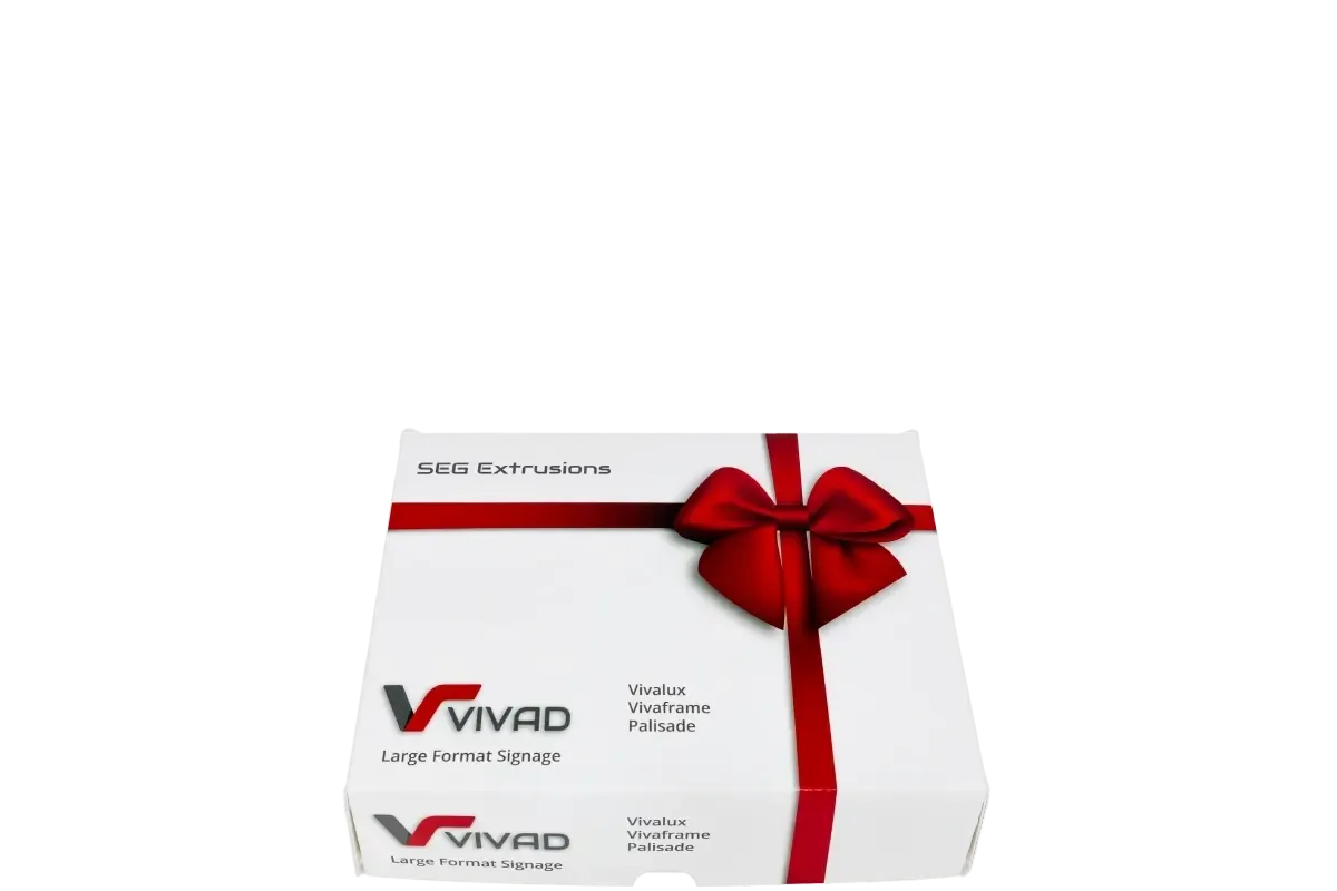 White gift box with red ribbon and bow, featuring the Vivad "Large Format Signage" logo.